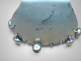 a close up of a metal object with bells on it