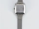 an image of a watch on a white surface with a white background
