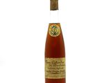 an image of a bottle of wine sitting on top of a white surface