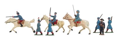 several figurines of men riding horses and holding spears