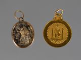 two gold and silver coin pendants with an image of a man and a woman