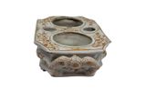 a small white and gold candle holder on a white background
