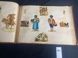 an open book with pictures of people and animals on it