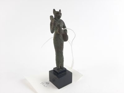 statue of a woman holding a basket on a marble base