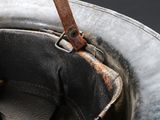 a close up of a helmet with a leather strap on it