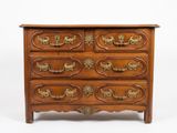 a wooden chest of drawers with gold handles on it