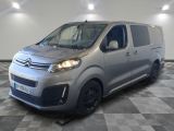 the silver van is parked in a room with a checkered floor
