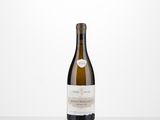 a bottle of white wine sitting on top of a table