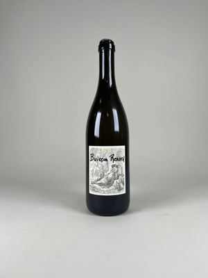 a bottle of wine sitting on top of a white table