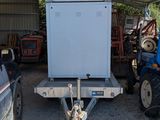 a white refrigerator sitting in the back of a trailer