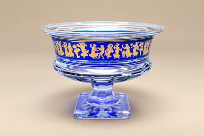 a glass bowl with a blue and gold design on it