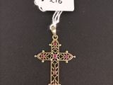 a cross with a tag attached to it on a black surface
