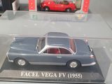 two model cars in a display case on a table