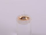 a clear glass with a gold ring on top of it