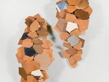 a sculpture made out of cardboard pieces on a white surface