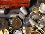 a pile of silver and gold items on a table