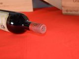 a bottle of wine sitting on a table next to a box of wine