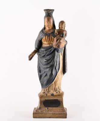 an old statue of a woman holding a child on a pedestal