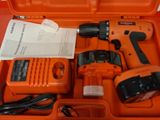 an orange tool box with tools in it sitting on a table