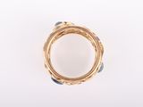 an image of a close up of a gold ring on a white surface