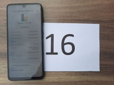 a picture of a cell phone next to a paper with the number 16 on it