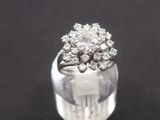 a close up of a diamond ring on a black surface