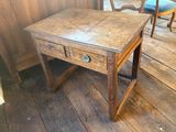 a small wooden table with two drawers on top of it