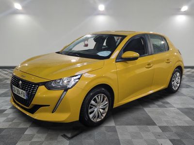 a yellow car parked in a garage with a checkered floor