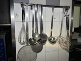 a picture of a kitchen with a bunch of utensils hanging on the wall