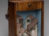 a wooden box with a picture of a house inside of it