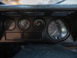 a close up of a car dashboard with a speedometer and gauges
