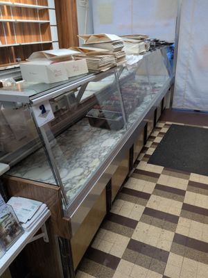 a large display case in the middle of a kitchen