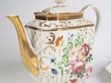 two plates and a teapot on a white table