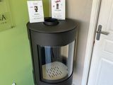 an image of a corner of a room with a stove and a door