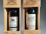two bottles of wine in wooden boxes with labels on them