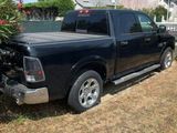 a truck that is parked in the grass in the yard