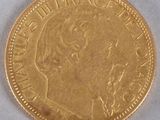 a close up of a gold coin on a white surface