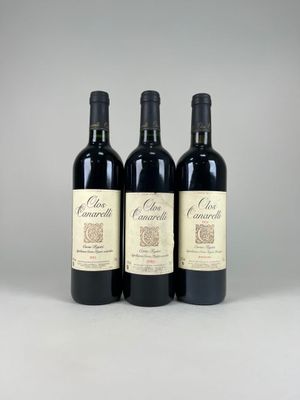 three bottles of red wine sitting next to each other on a table