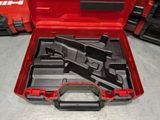 a red tool case with tools in it on a table