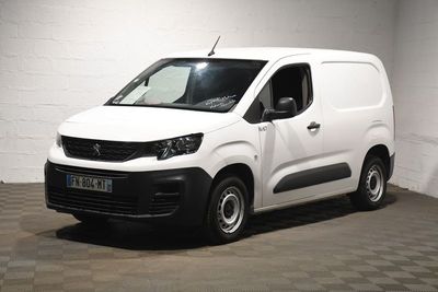 the white van is parked in a large room with a checkered floor
