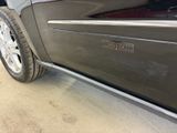a close up of a car ' s door handle with a sticker on it
