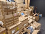 many boxes stacked on top of each other in a room