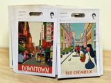 two boxes with posters on them sitting on a table