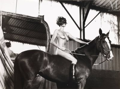 a woman that is sitting on a horse in a barn