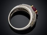 an image of a diamond and ruby ring on a black surface