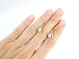 a woman ' s hand with two rings on it