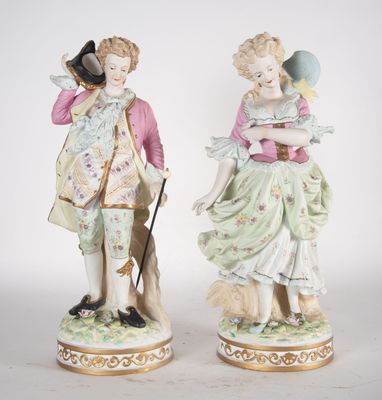 paire de figurines en porcelaine représentant un homme et une femme accompagnés d'un chien
