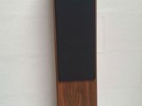 a close up of a wooden speaker on a white surface