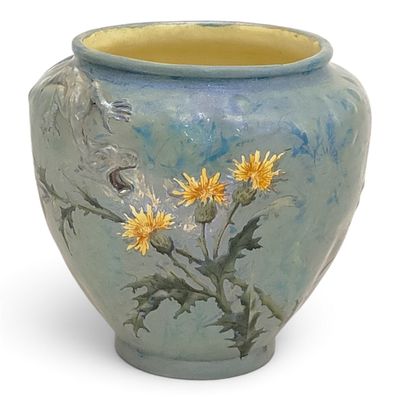 a blue vase with yellow flowers painted on it