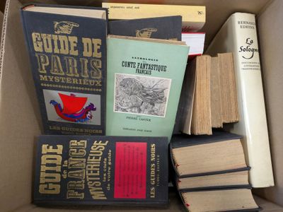 many books in a box that are sitting on the floor